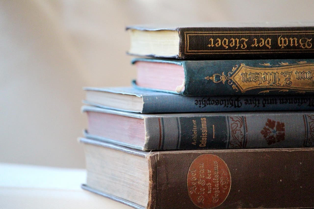 A stack of old cloth-bound books